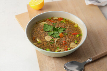 Bowl of tasty lentil soup on table