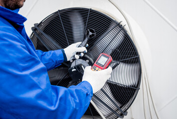 Testing with an anemometer of an axial fan of the condensing unit - obrazy, fototapety, plakaty
