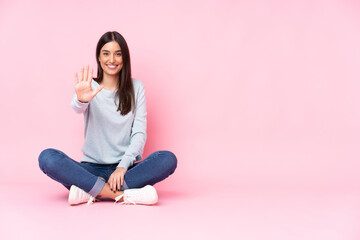 Young caucasian woman isolated on pink background counting five with fingers