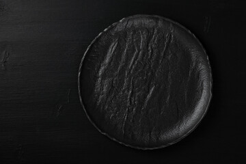 Empty metal tray on a black background. Space for text