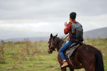 woman hiker with backpack riding horse travel freedom
