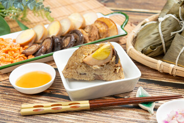 rice dumpling is a traditional Chinese rice dish made of glutinous rice and wrapped in bamboo leaves, Dragon Boat Festival is making and eating zongzi with family