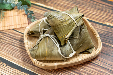 rice dumpling is a traditional Chinese rice dish made of glutinous rice and wrapped in bamboo leaves, Dragon Boat Festival is making and eating zongzi with family