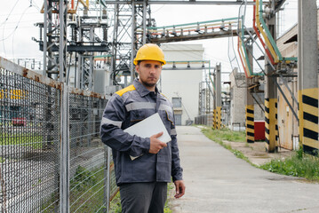 The energy engineer inspects the equipment of the substation. Power engineering. Industry