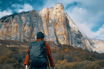 Naklejka premium woman hiker backpack travel mountains clouds nature