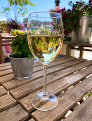 A glass of champagne on the table in a street cafe in the center of St. Petersburg. Summer vacation in the city.