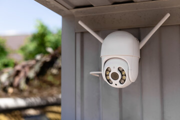 modern CCTV wifi surveillance camera installed on the garage for home security system. Anti-theft system concept. © Mila Naumova