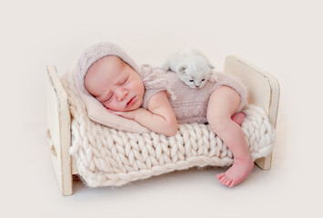 Newborn sleeping with kitten © tan4ikk