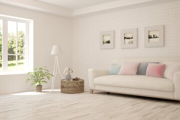 White living room with sofa and summer landscape in window. Scandinavian interior design. 3D illustration