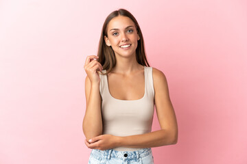 Young woman over isolated pink background laughing