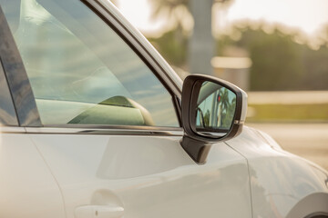 Side view mirror and window from a vehicle perspective. 