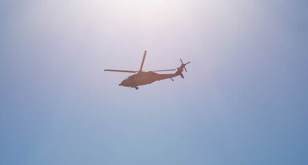 Military helicopter on blue background.