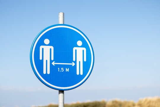Social distancing sign at the beach asking to keep 1.5 meters distance due to the corona virus