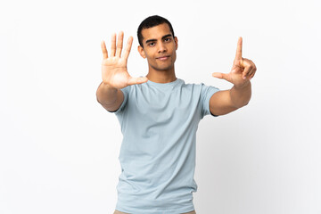 African American man over isolated white background counting seven with fingers