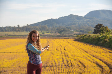 Woman showing a rice field.