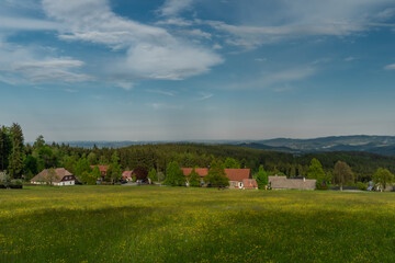 Fototapeta na wymiar Meadows and forests near Javornik hill and village in Sumava national park