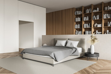 Light bedroom interior, grey bed with linens and coffee table, bookshelf on background © ImageFlow