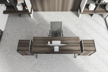 Luxury CEO office interior with dark wooden table, computer and bookcase, top view
