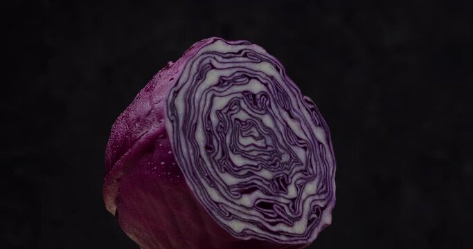 Close-up of red cabbage rotate on dark background.