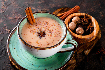 Masala tea. Indian traditional tea with milk and spices in a cup close up