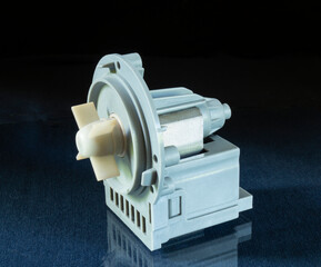 Washing machine pump on blue table with reflection