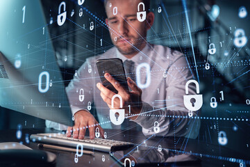 Businessman in casual wear checking cyber security using smart phone to protect clients confidential information. IT hologram lock icons over modern office background at night time.