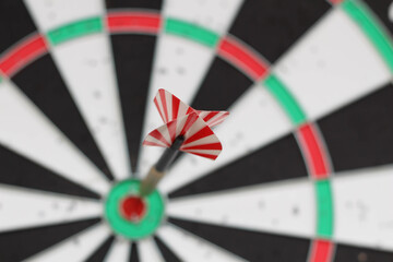 Conceptual photo. Darts on dart board outdoors in summer. Throw darts at the target. The winner,...