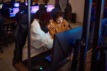 Obraz na płótnie Canvas Two gamers having fun in gaming club