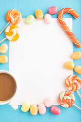 Composition with candies frame on blue pastel background. copy space, top view.