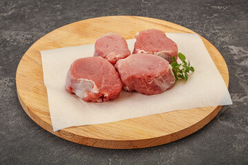 Raw pork medallion served rosemary