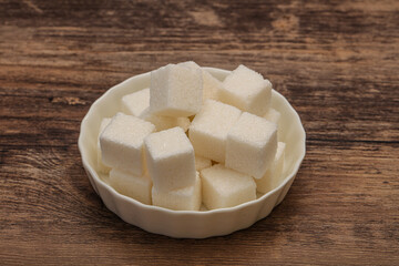 Refined white sugar cubs in the bowl