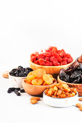 Assortment of nuts and dried fruits. Healthy snacks. Dried apricots, figs, raisins, pecans, walnuts, hazelnuts, almonds and other. White background