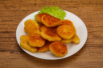 Fried chicken nuggets served salad leaves