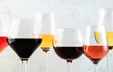Wines assortment. Red, white, rose wine in wineglasses and bottles on gray background. Wine bar,...