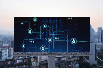 Glowing Social media icons on billboard over sunset panoramic city view of Kuala Lumpur, Malaysia, Asia. The concept of networking and establishing new connections between people and businesses in KL