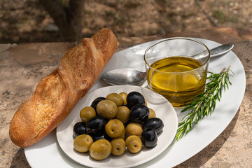 Green and black olives,olive oil,herbs and bread.Rustic food photography.