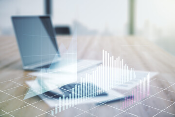 Multi exposure of virtual abstract financial graph interface on blurry calculator and computer background, financial and trading concept