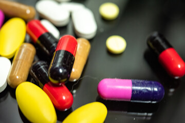 Pharmaceutical medicine pills in both tablets and capsules with the vintage retro picture style. Pharmacy theme and treatment medication as concept.	
