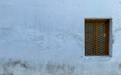 Old window on background in a village.