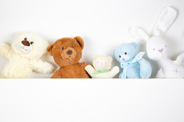 Fluffy toys teddy bears and white bunny with white background. Top view, copy space for text
