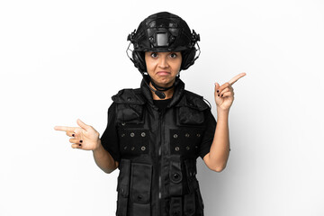 SWAT woman isolated on white background pointing finger to the laterals and happy