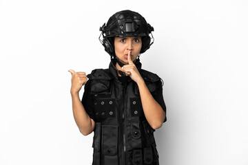 SWAT woman isolated on white background pointing to the side and doing silence gesture