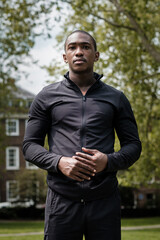 Portrait of black male athlete posing in a park.