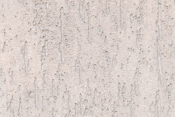 Abstract textured background. Close-up view of beige weathered concrete wall. Copy space for your text and decorations. Construction theme.