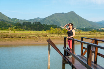 Enjoying the landscapes from the wooden piers of the Urdaibai marshes, a Bizkaia biosphere reserve next to Mundaka. Basque Country