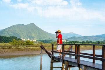 Fototapeta na wymiar Watching birds with spyglasses from the wooden piers of the Urdaibai marshes, a biosphere reserve in Bizkaia next to Mundaka. Basque Country