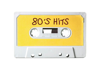 An old vintage cassette tape (obsolete music technology) with the handwritten text: 80's hits....