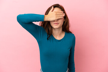Young caucasian woman isolated on pink background covering eyes by hands. Do not want to see...