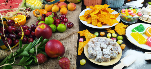 Fototapeta na wymiar fresh fruits and unhealthy foods for healthy eating
