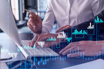 Two traders man and woman researching historic data to predict stock market behavior using laptop....